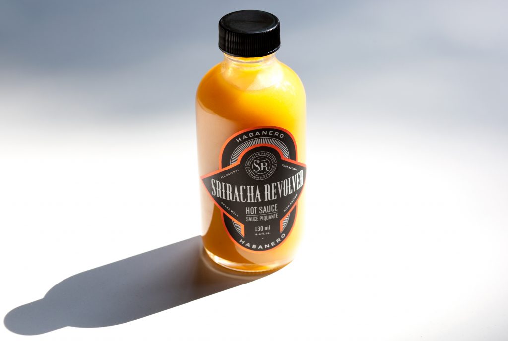 Bottle of yellow habanero hot sauce by Sriracha Revolver
